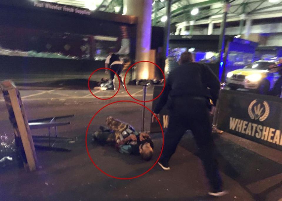  Three men - two lying in the background - believed to be the terrorists pictured dead after being shot by police