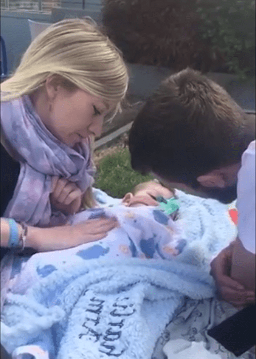  The video shows mum Connie and dad Chris 'having a picnic' with little Charlie