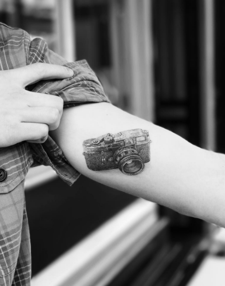  His second tattoo, a camera on his arm, paid tribute to the teen's love of photography