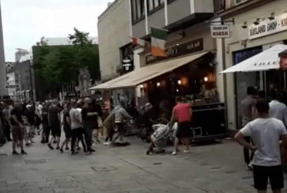  One of the men on the floor appears to be kicked in the head by another man