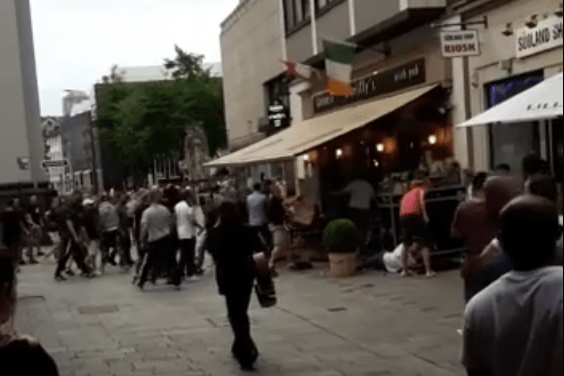  The mob appear to hurl tables and chairs towards those inside the pub