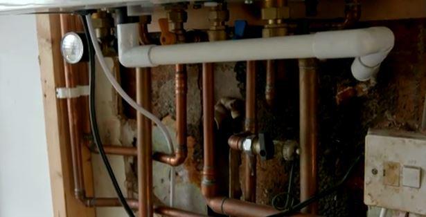  The exposed pipes in the kitchen around the boiler