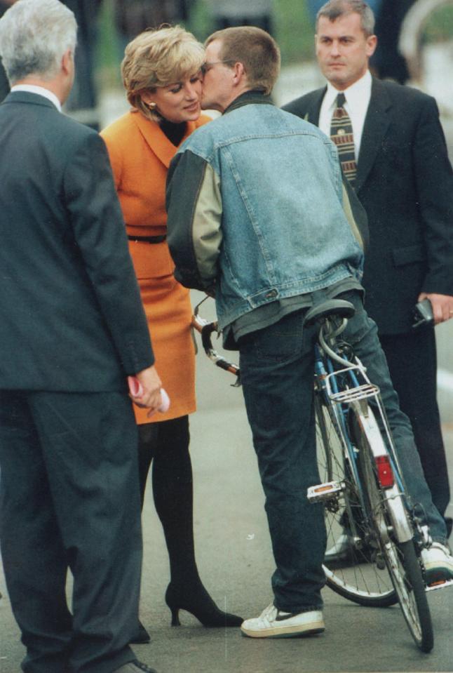  A Liverpool man plants a kiss on the Princess of Wales' cheek during her 1995 visit to the city