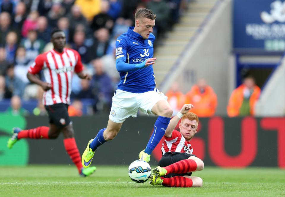  Midfielder Reed makes a sliding tackle on Jamie Vardy