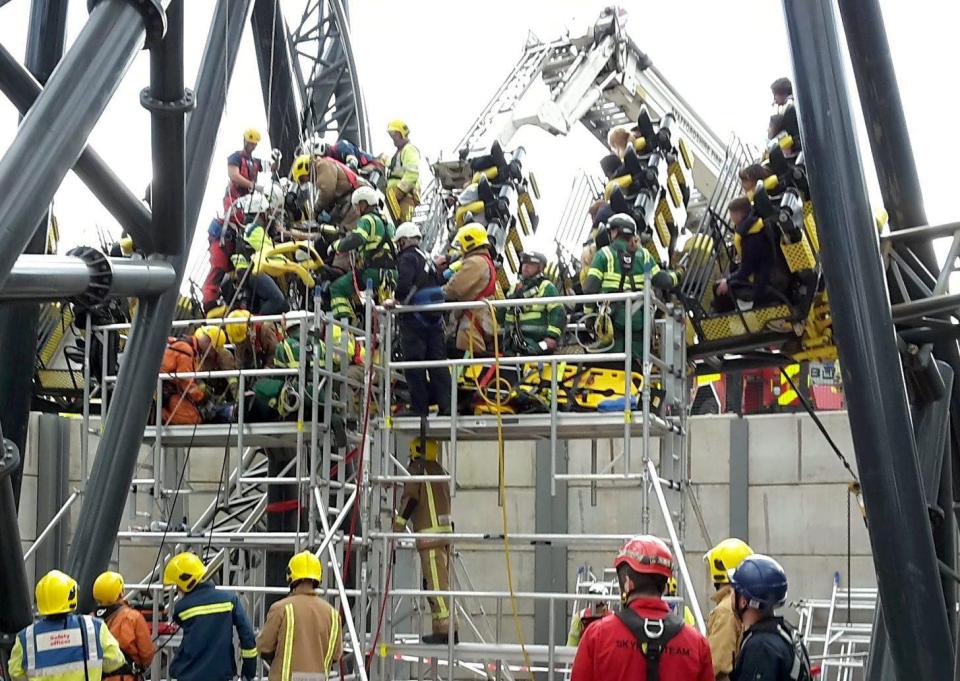  Rescue workers assist the victims after two cars collided on the rollercoaster at Alton Towers