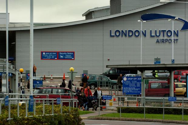 A man was arrested at Luton Airport for allegedly trying to open the door of a plane mid-flight