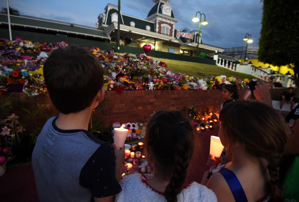  Mourners lay flowers and light candles outside Dreamworld after the tragedy in October 2016