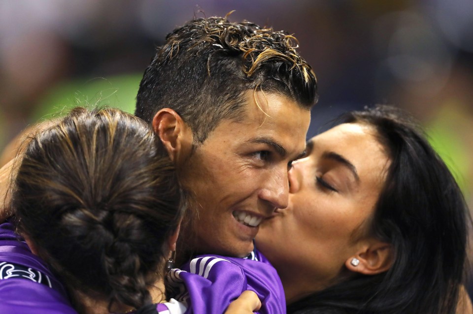 Georgina Rodriguez kisses Cristiano Ronaldo on the cheek after his Champions League triumph this year