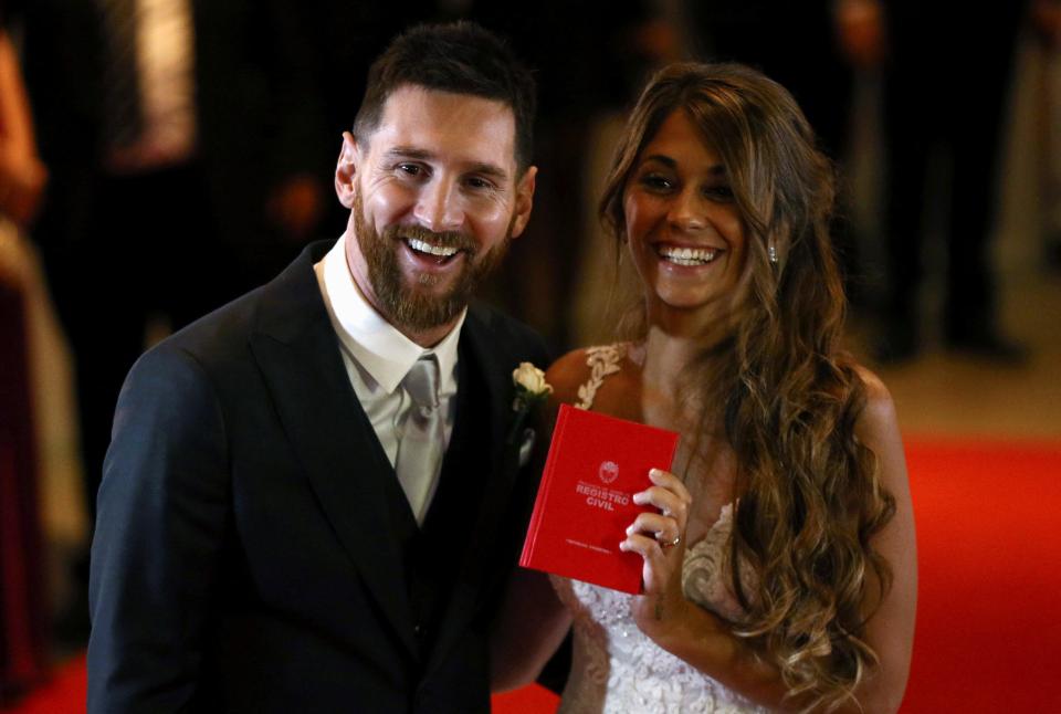  Lionel Messi and Antonella smile on the red carpet after completing their vows in front of family and friends