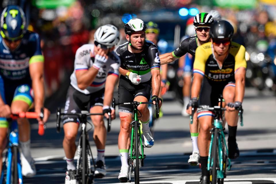  Mark Cavendish crosses the line nursing his right shoulder at the conclusion of the fourth stage of the Tour de France