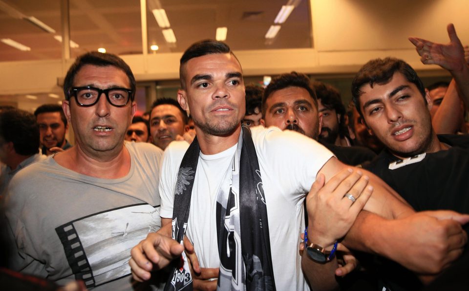  Pepe is escorted out of the airport as he is mobbed by hundreds of fans in Istanbul