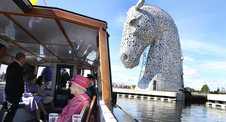  Queen Elizabeth II and the Duke of Edinburgh arrive by boat to visit the 30 metre-high artwork featuring two horse heads