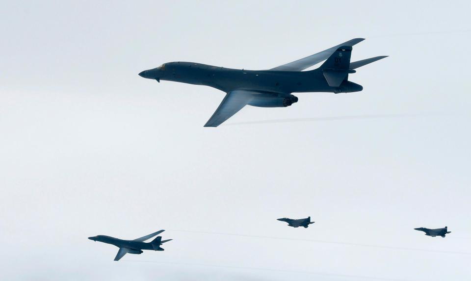  The B-1B Lancers (top and L) flying over South Korea during a joint live fire drill