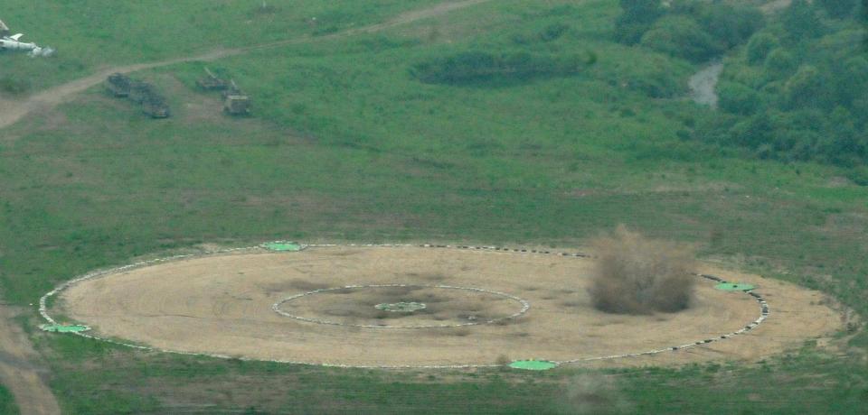  The bomber's weapons are seen hitting their targets on the ground