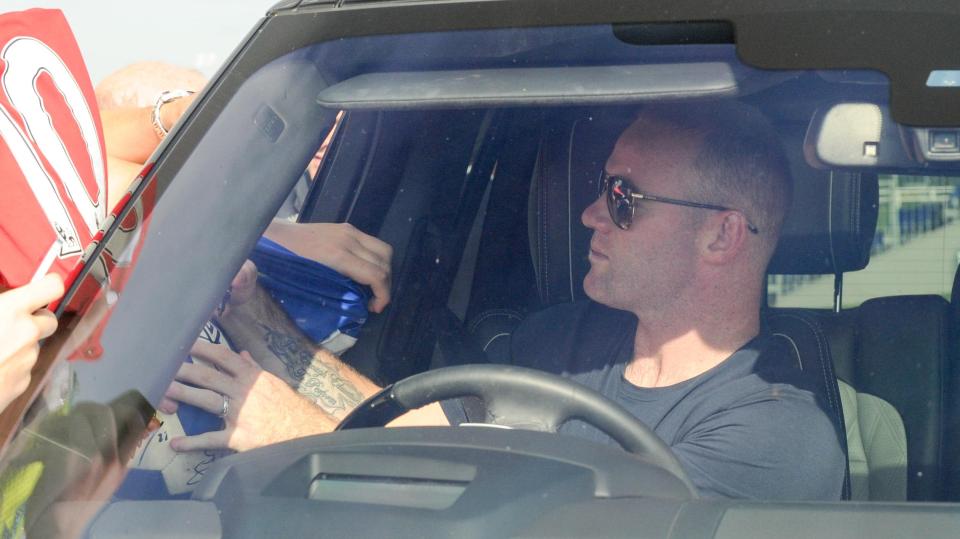  Wayne Rooney was happy to sign autographs for fans as he left Finch Farm