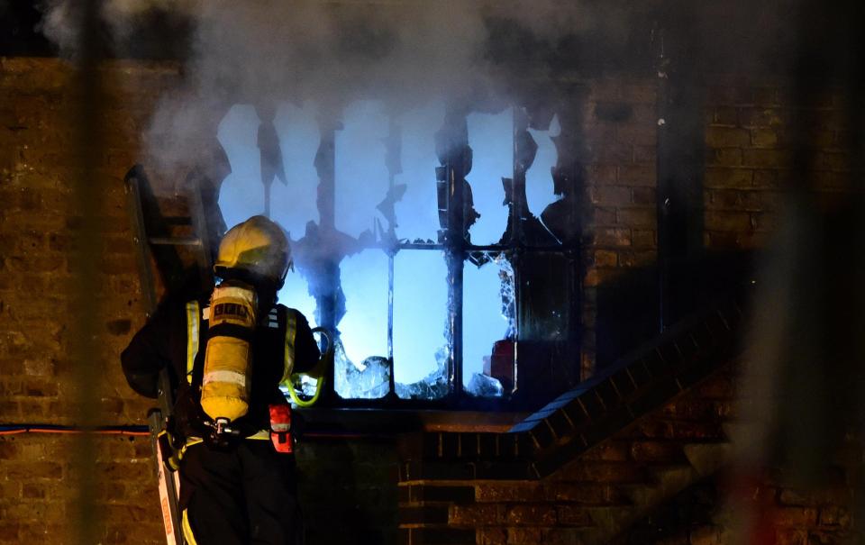  A firefighter helps keep the blaze under control in the early hours of Monday