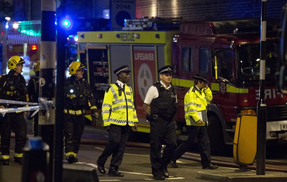  Police officers pictured in Camden as firefighters successfully battled the inferno