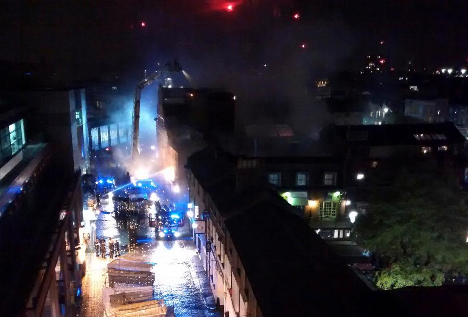  Fire workers pictured dampening down hot spots on Monday morning