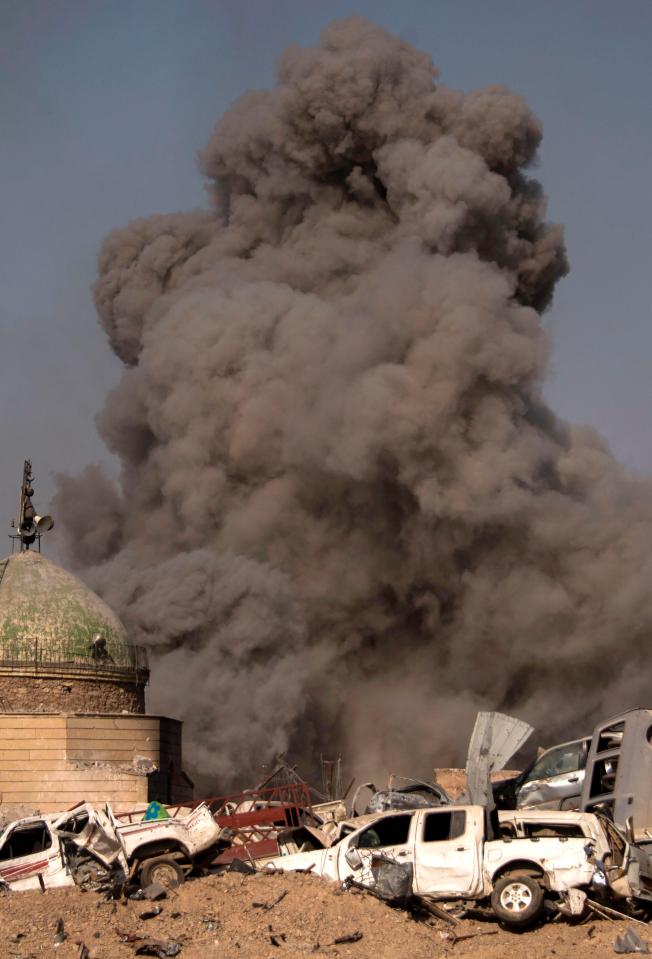  A large dark cloud of smoke billows in the Old City of Mosul during the Iraqi force fight against ISIS