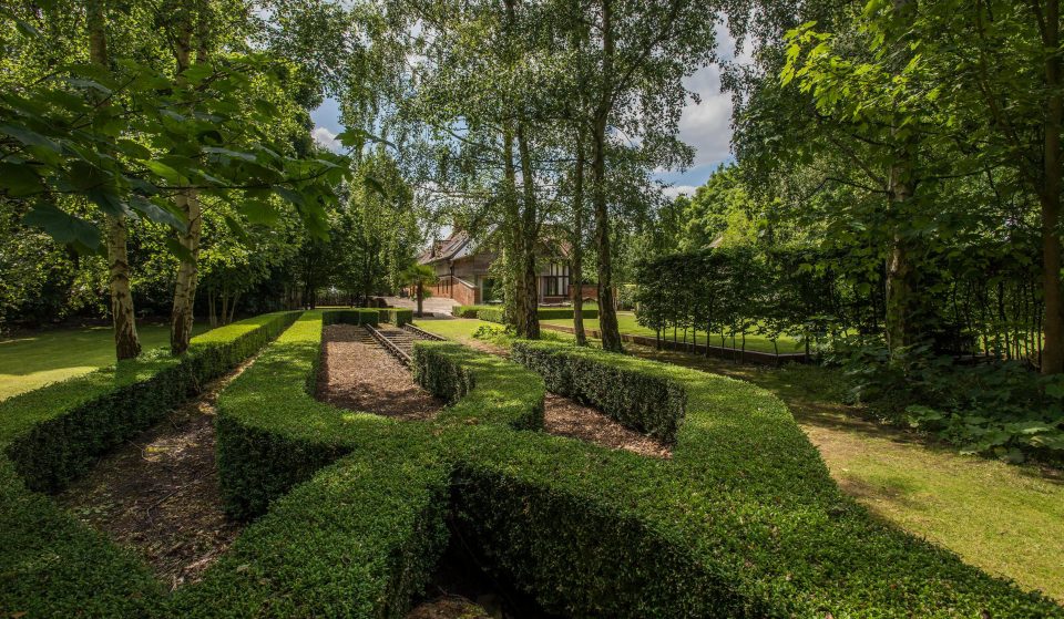  Neatly-clipped box hedging surrounds a short section of track that remains