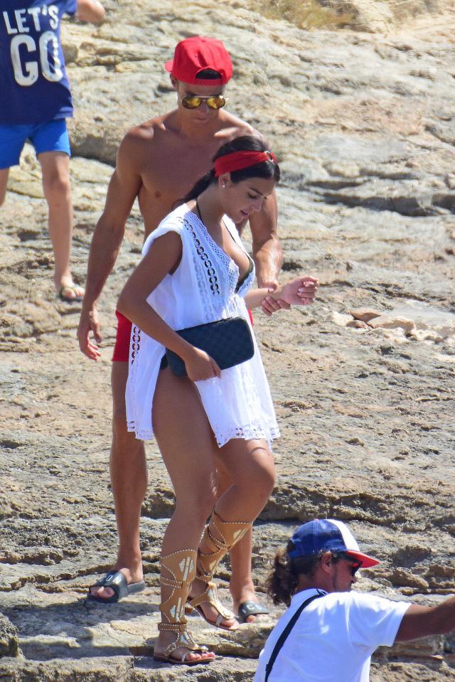  Georgina carefully makes her way along the beach in Ibiza with Cristiano Ronaldo