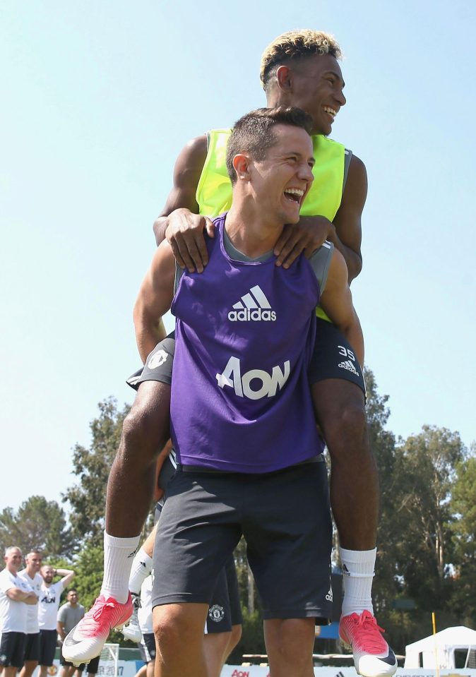  Ander Herrera gives Demitri Mitchell a lift in the first team training session