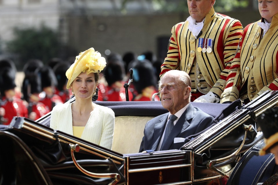 Queen Letizia chats to Prince Philip in a state carriage following the horse parade