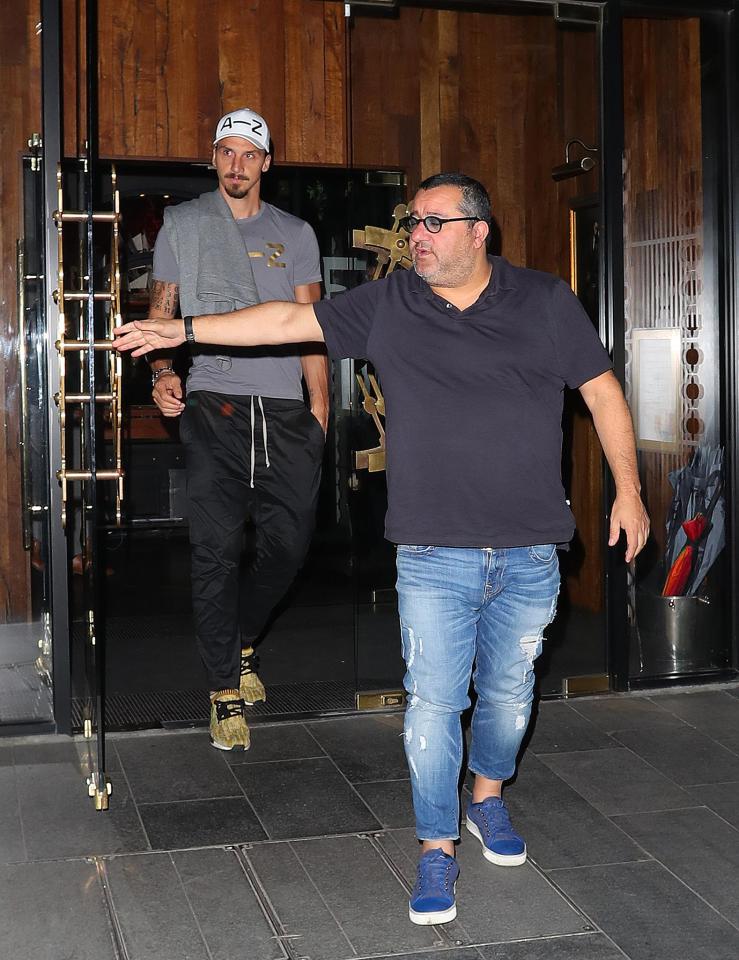  Mino Raiola holds the door for his client Zlatan Ibrahimovic as he leaves Tattu restaurant in Manchester