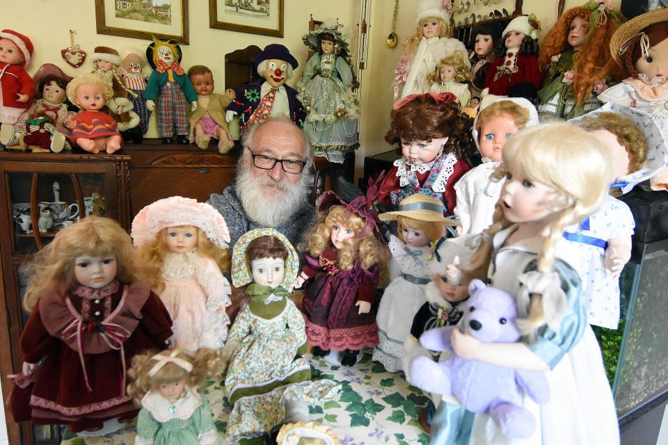  A family has likened a dad's collection of dolls to a horror film and even claim the toys are haunted