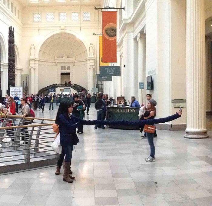  Armless fun? A gallery visitor captured this comical panoramic image of a woman taking a selfie - and what appears to be her VERY long arm