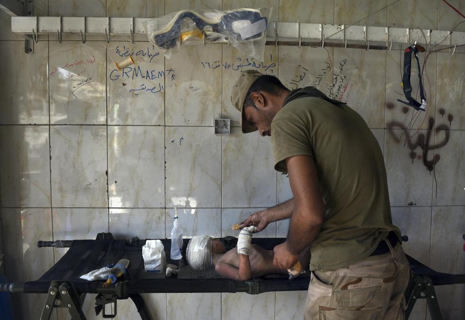  One youngster receives emergency treatment after he was found all alone in the ruins of Mosul's battleground