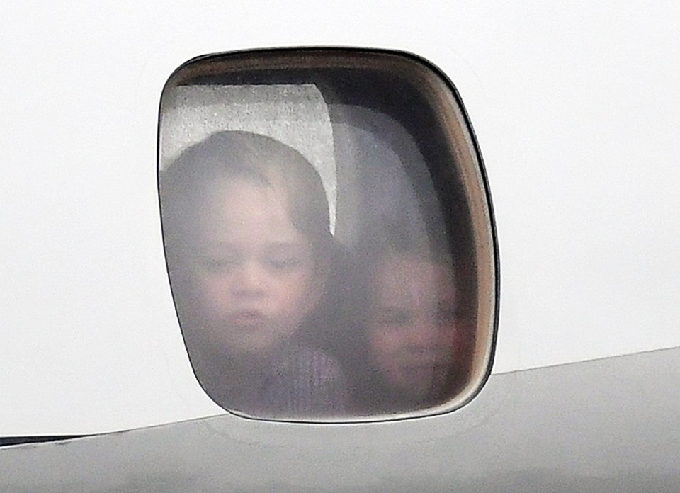 The young royals pressed their faces against the plane window as they touched down