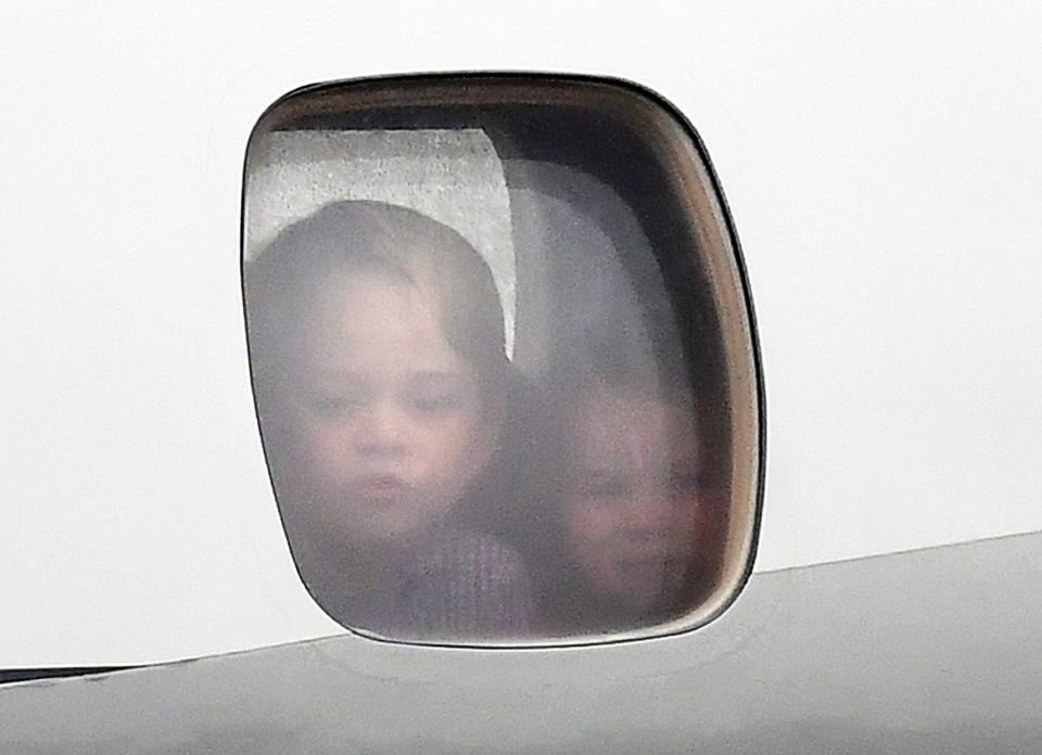  The young royals pressed their faces against the plane window as they touched down