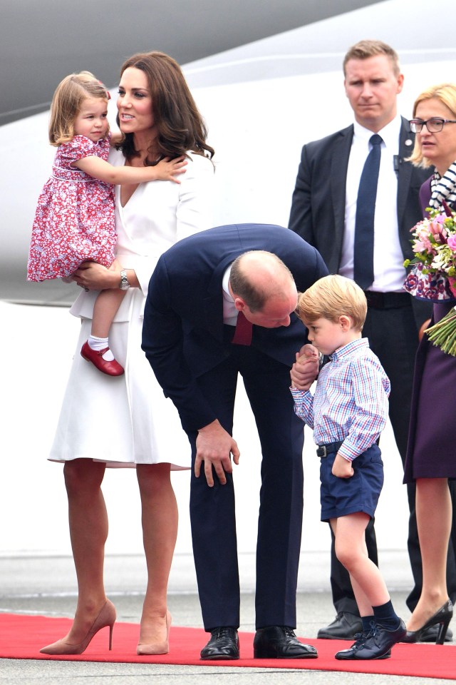  Prince William has a quick word with a nervous looking George as the arrive in Warsaw