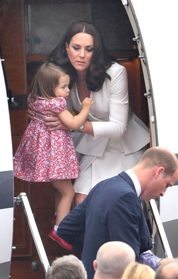  Kate scoops up little Charlotte to help her off the private jet