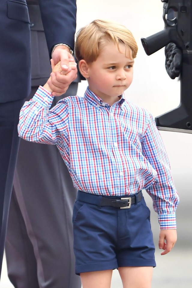  George held on to his dad's hand as he walked down the red carpet