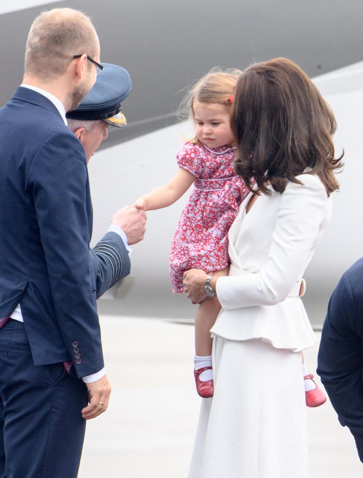  Charlotte practises the art of the royal greeting as she arrives in Poland