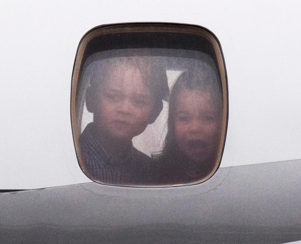  Prince George and Princess Charlotte make faces from inside the plane