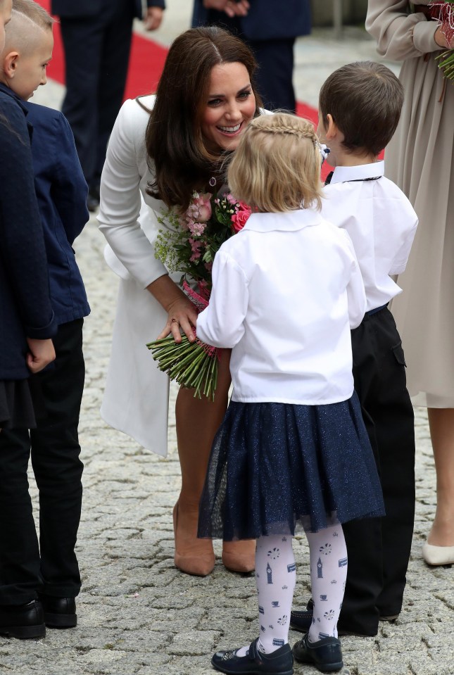 Kate takes time to speak with youngsters on her and Will's first visit official visit to Poland