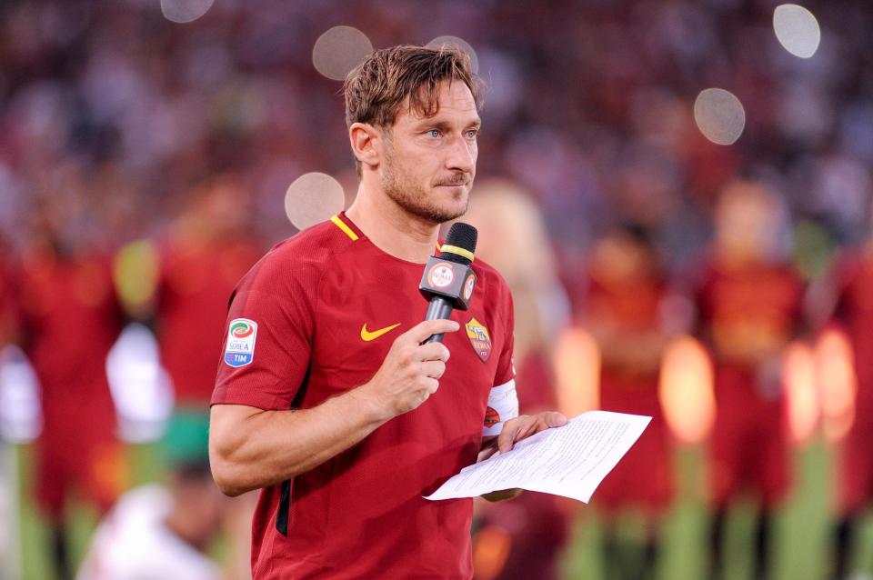  Francesco Totti waves reads a goodbye message to Roma fans