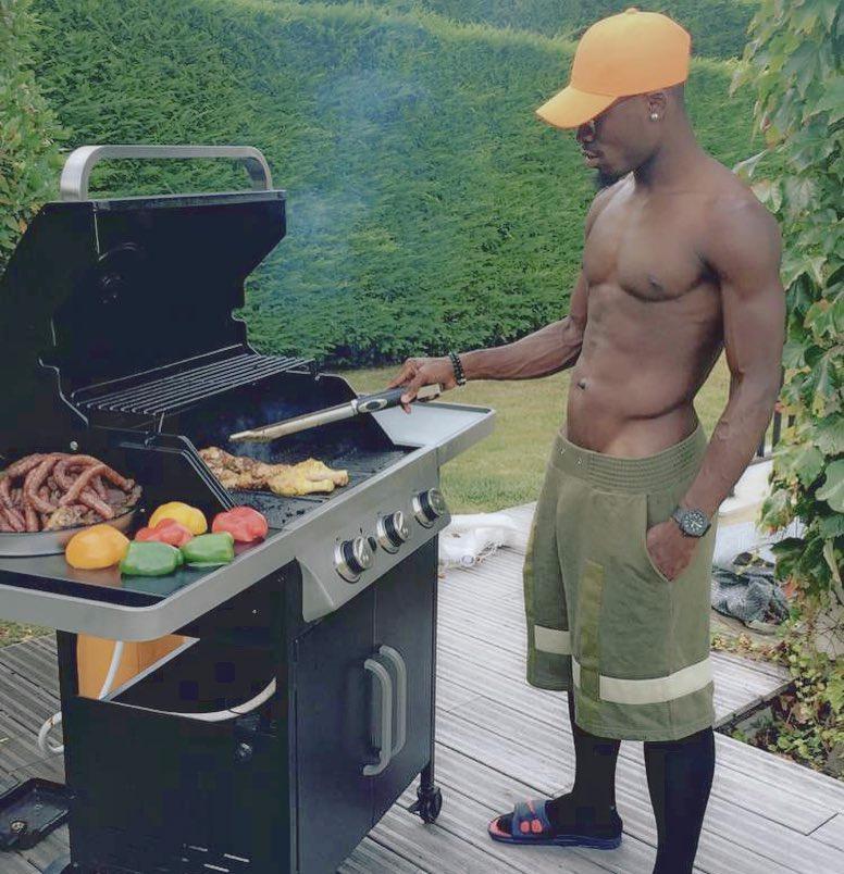  Serge Aurier pictured cooking on a barbecue with his shirt off