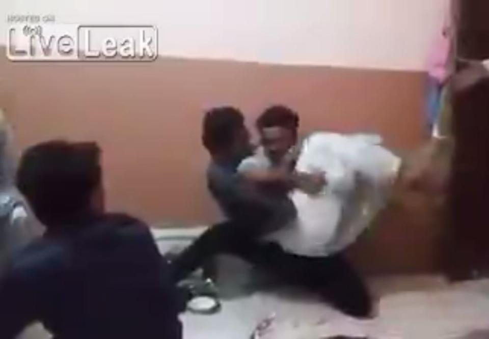  One man tries to wrestle him to the ground but he scoops him up in his arms and continues his bizarre rampage