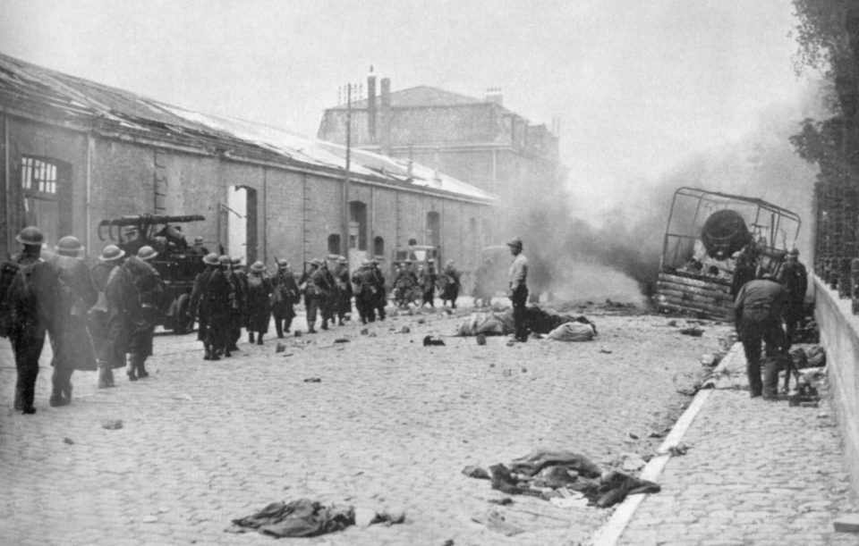  Another photo in historian Henry Buckton's new book shows French troops marching through a Dunkirk street littered with debris