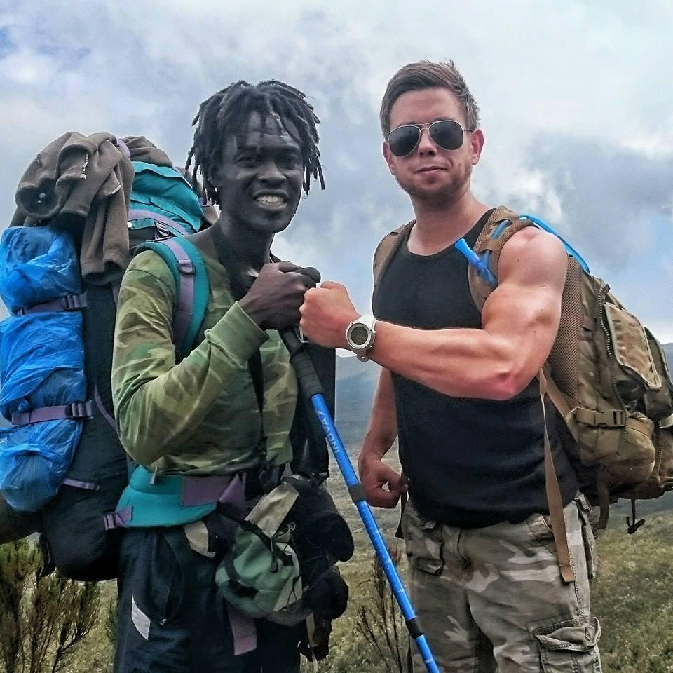 Mark Lloyd, 33, pictured posing with an African guide during his five-day trek to the summit of Mount Kilimanjaro in Tanzania