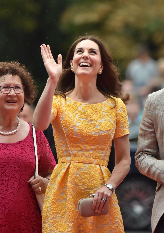 Beaming Kate waves at well-wishers as she arrives in the German city of Heidelberg