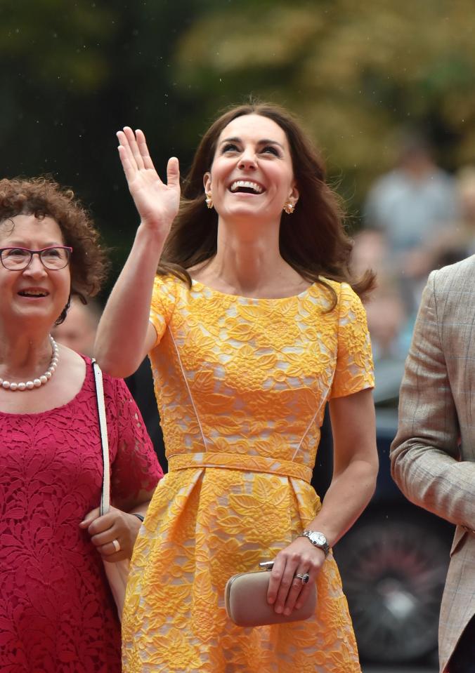  Beaming Kate waves at well-wishers as she arrives in the German city of Heidelberg