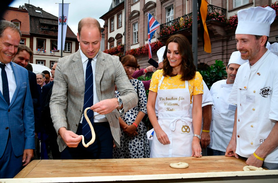 Kate laughs as Wills dangles dough and tries to press a pretzel