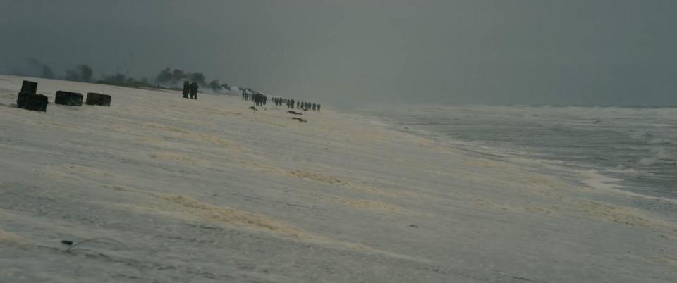  As a few lingering troops await their rescue huge plumes of smoke can be seen rising from the Dunkirk coastline in a haunting scene from the movie