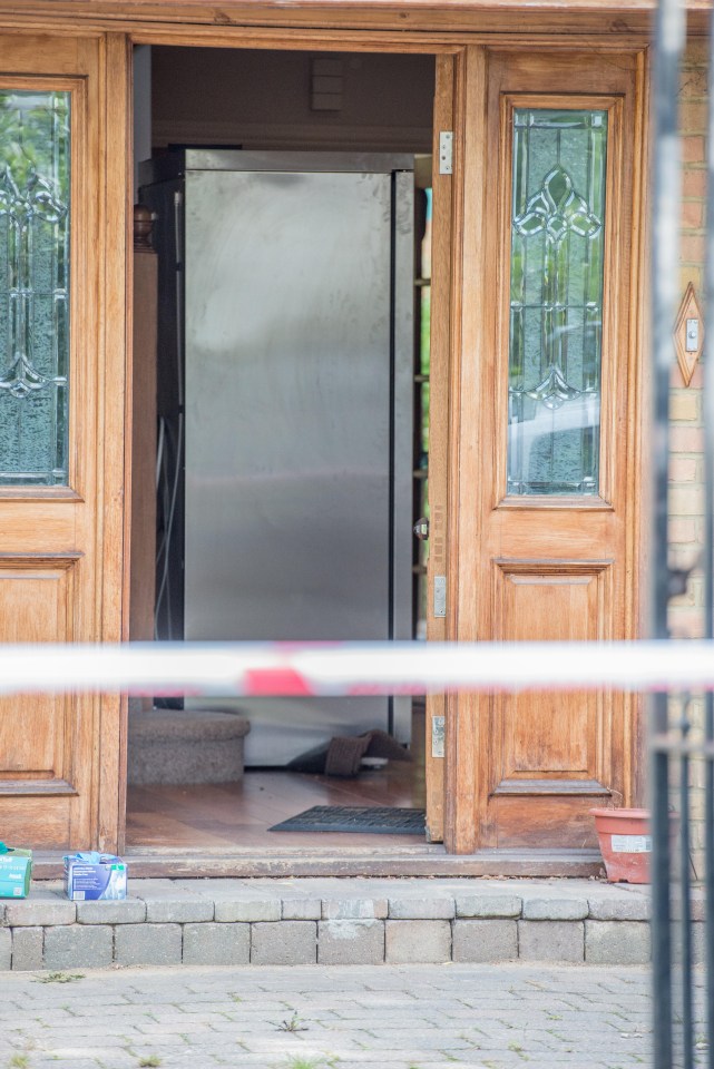 A silver fridge-freezer could be seen behind the police cordon