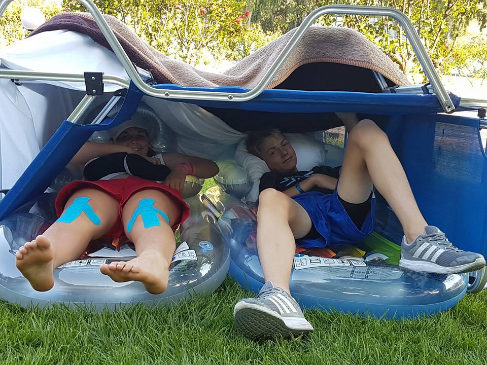 Dana, 13, and 12-year-old Jack Liddell from Perthshire in a shelter made from sun loungers and pool inflatables